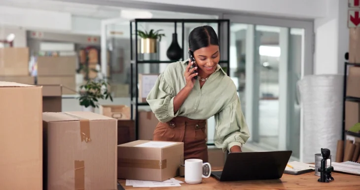 woman on the phone next to parcels